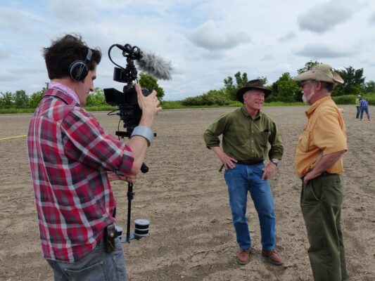 A camera man captures Dr. Blakeslee being interviewed for Sunflower Journeys.