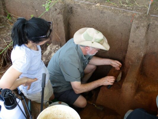 Dr. Blakeslee demonstrates excavation to a student.